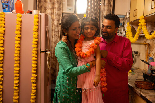Family enjoying festive decoration at home.