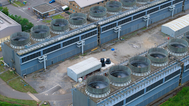 Aerial view of the cooling towers at Little Barford Power Station, showing the industrial facility with large circular fans and surrounding paved areas in St. Neots, England, United Kingdom.