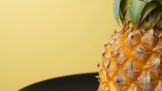 Fresh tropical fruit pineapple turning close up, text space.