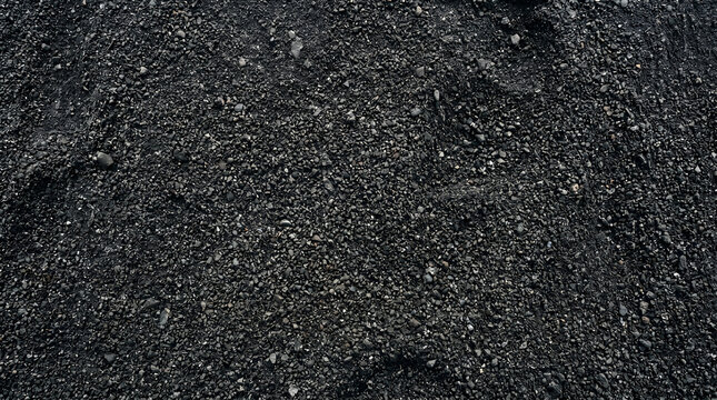 Coarse dark asphalt texture or black volcanic sand background for industrial and construction design materials