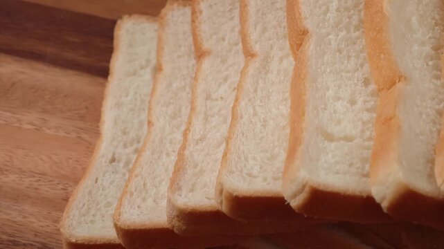French bread slices on wooden cutting surface
