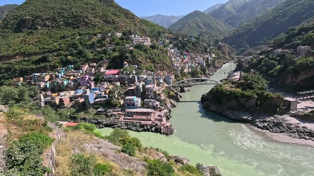 anoramic establishing shot of Devprayag mountain town and the magnificent sacred river confluence in Uttarakhand.