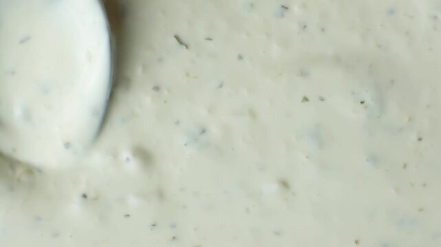 Spoon demonstrating the thick texture of creamy tartar sauce