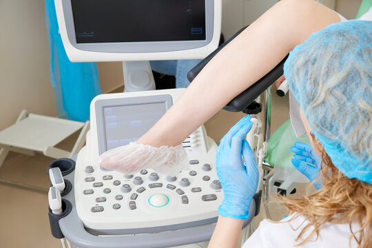 Cropped view of gynecologist and patient doing ultrasound scan