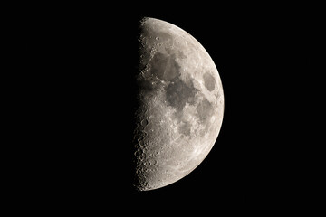 Fototapeta premium A crescent moon is visible against the blackness of space.