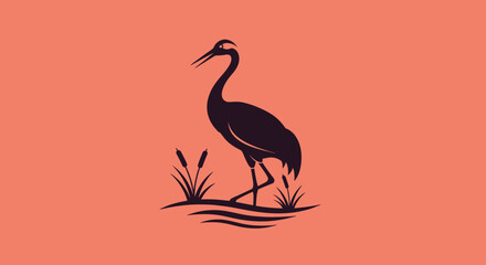 Fototapeta premium Black crane silhouette standing in reeds on orange