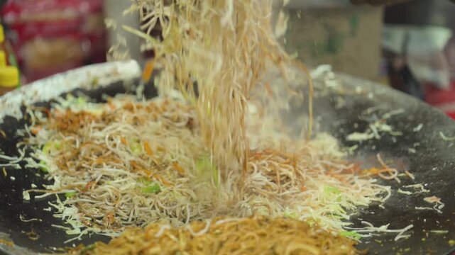 Street Style Chowmein Cooking, Indian Street Food Noodles, Fresh Veg Chowmein Preparation, Hot Noodles on Large Tawa stock video.