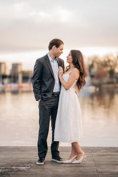 Romantic couple gazing at each other on a dock