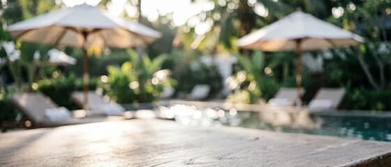 Fototapeta premium Blurred Poolside Lounge Area with Umbrellas and Sunbeds for Relaxation Concept