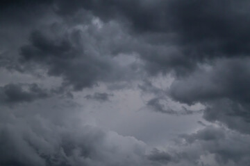 Fototapeta premium Dramatic dark storm clouds filling the sky, ominous cloudy weather background before rain.