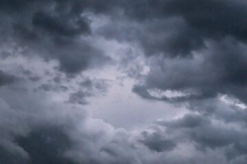 Fototapeta premium Dramatic dark storm clouds filling the sky, ominous cloudy weather background before rain.