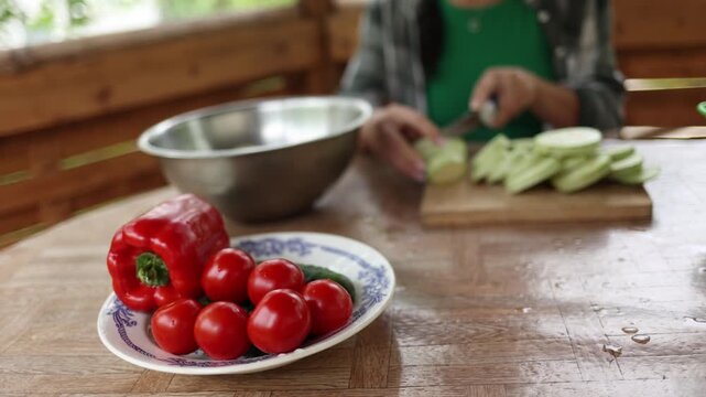 Woman slicing fresh zucchini for a healthy vegetable salad
