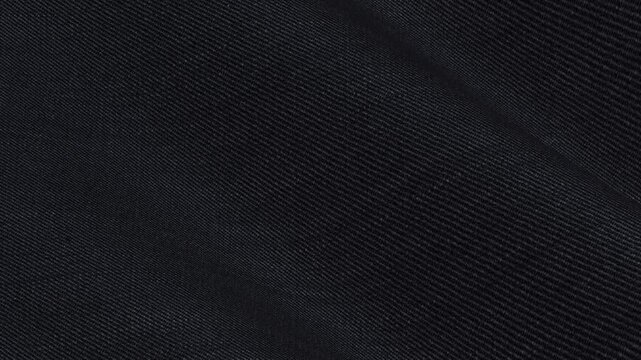 Premium Italian Obsidian Black Solid Wool Lycra Fabric rippling in smooth matte waves of flexible executive suiting texture for formal garments