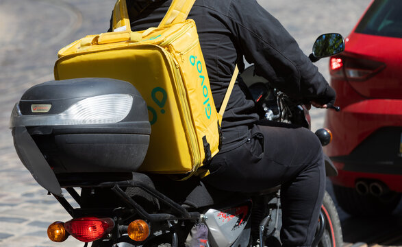 Express Food Delivery Courier Riding Motorcycle In Lviv Ukraine