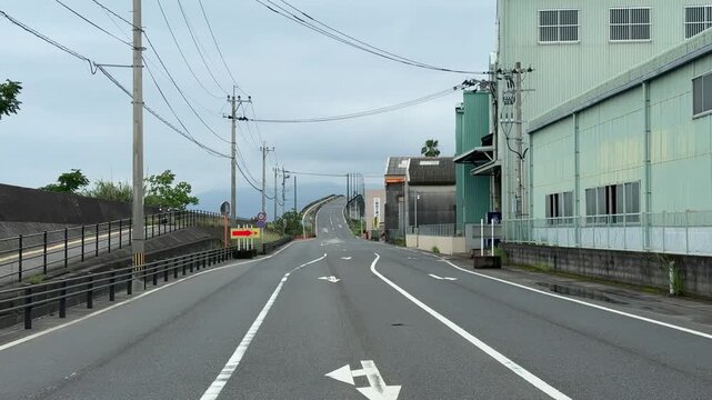 Empty steep roller coaster road leading up to a bridge in Kagoshima, Japan