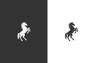 Fototapeta premium A powerful silhouette of a horse rearing up on its hind legs, presented in both black and white