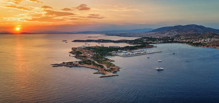 Aerial view of the south coast of Athens, Greece, with Vouliagmeni bay, Laimos peninsula and Astir beach during a beautiful summer sunset