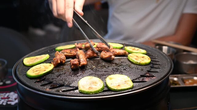 Grilling Chicken and Vegetables on a Korean BBQ Table with Steam