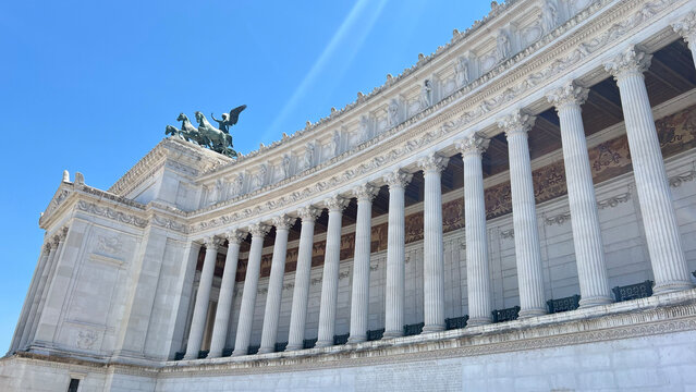 The Victor Emmanuel II National Monument in Rome, Italy. Rises in bright daylight with monumental columns, statues, and classical architecture, also known as the Vittoriano.