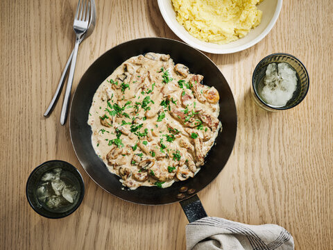 Creamy mushroom chicken skillet with mashed potatoes and side drinks, family dining experience, home cooking concept