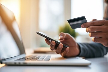 Fototapeta premium Businessman paying online with credit card and smartphone