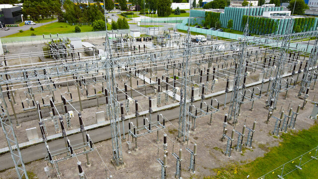 Industrial energy infrastructure featuring a complex electrical substation with transformers and switchgear connecting to power lines