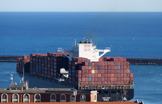 Genoa, Italy - June 2026: a cargo ship departing from the commercial port with Zim and Tex containers on board. 