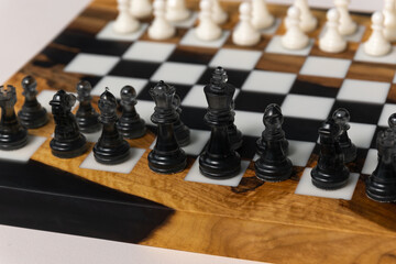 There are black pieces on the chessboard: pawns, a knight, a bishop, and a rook. Selective focus on the black pieces. © Natalya Likhina
