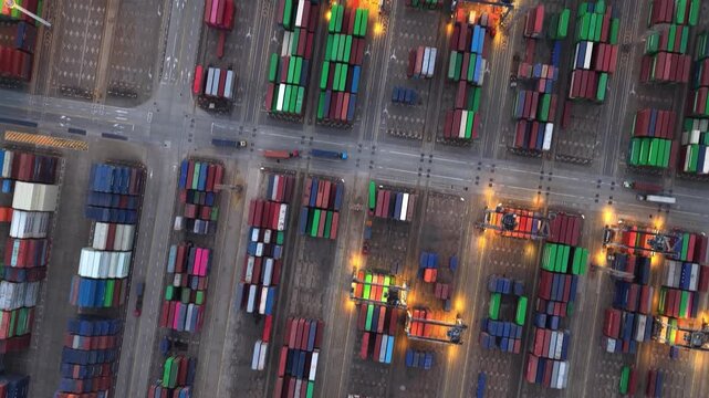 Unloading large cargo containers seaport. Loading freight sea port. Top aerial drone view. Lot big boxes rows, ship delivery ocean harbor. Industrial Shipping day. Goods export import. Marine dock.