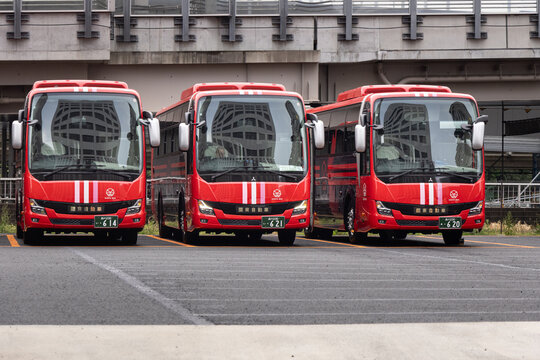 Tokyo, Japan April 16, 2026 row of modern red kanto buses parked at an urban depot in tokyo showing public transportation vehicles ready for service, kanto bus fleet parked at depot in tokyo