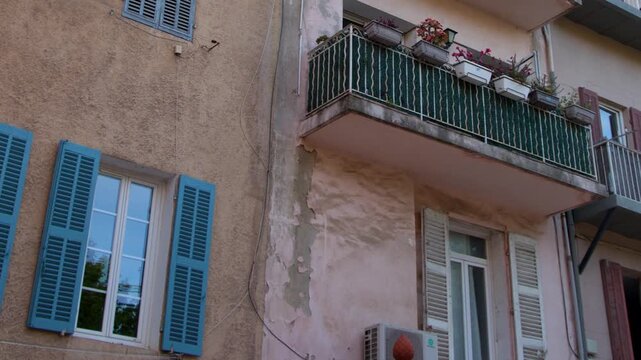 Traditional Mediterranean Apartment Building Facade with Blue Shutters in Cassis