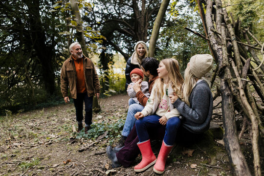 Family bonding and enjoying a multi generational outing in autumn woods