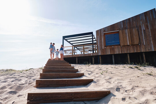 Father and mother with children moving down on steps
