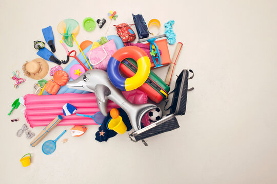 Vacation luggage with pool and beach accessories in studio