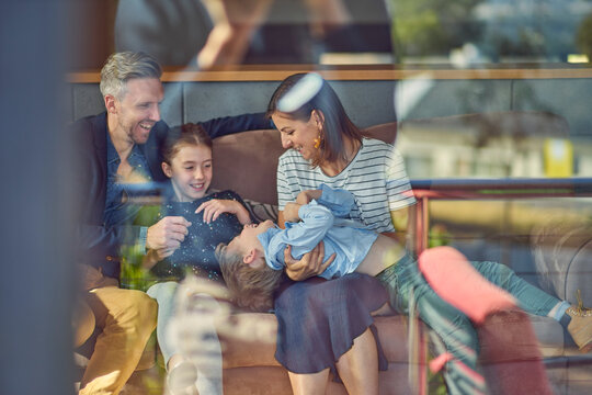 Happy family relaxing on the couch at home