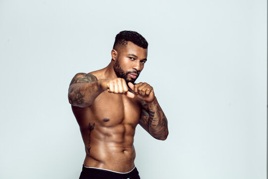 Portrait of tattooed physical athlete boxing