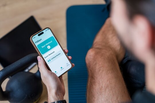Man using fitness app for exercise plan and motivation during workout