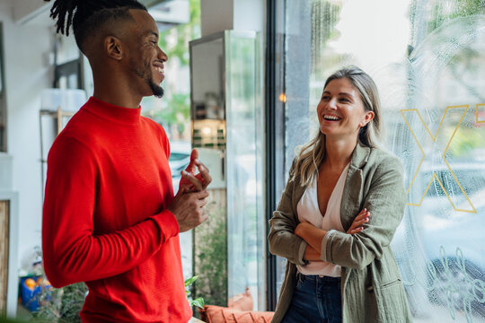 Happy businessman talking with colleague at cafe