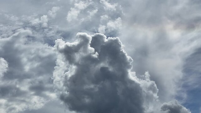 Dramatic backlit storm cloud with bright silver lining in a moody summer sky