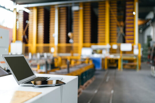 Laptop and digital tablet in logistics center