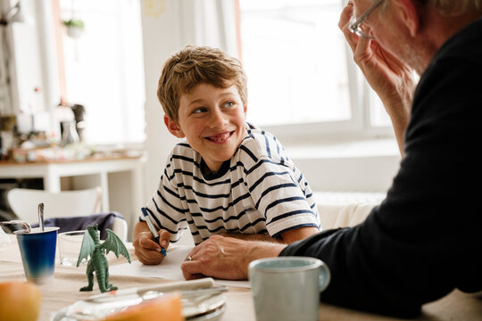 Father and son doing math homework together at home