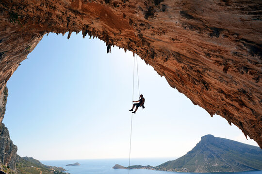 Greece, Kalymnos, climber abseiling in grotto