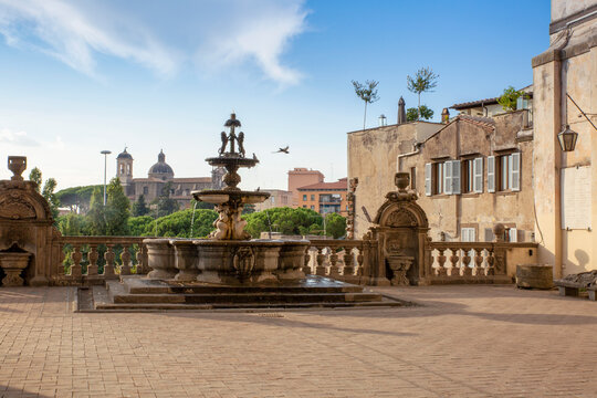 Italy, Lazio, Viterbo, Fountain and terrace of Palazzo dei Priori with Chiesa della Santissima Trinita church in background