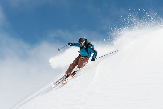 Skier in action on powder snow at Arlberg mountain