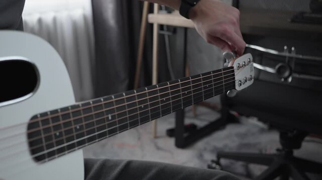 Tuning Acoustic Guitar Strings by Hand in Home Studio