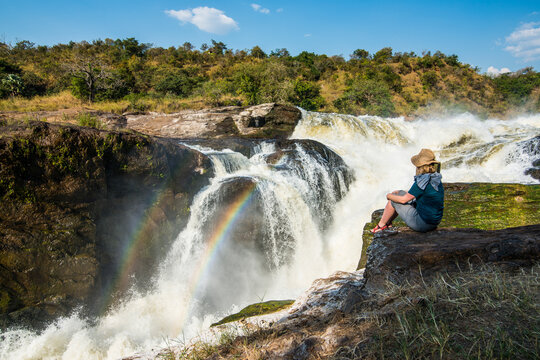 Africa, Uganda, Woman looks at the stunning Murchison Falls, on the Nile, Murchison Falls National Park