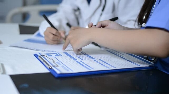 Multiracial doctors team advising about the treatment of patient using x-ray scan during meeting in office clinicMultiracial doctors team 