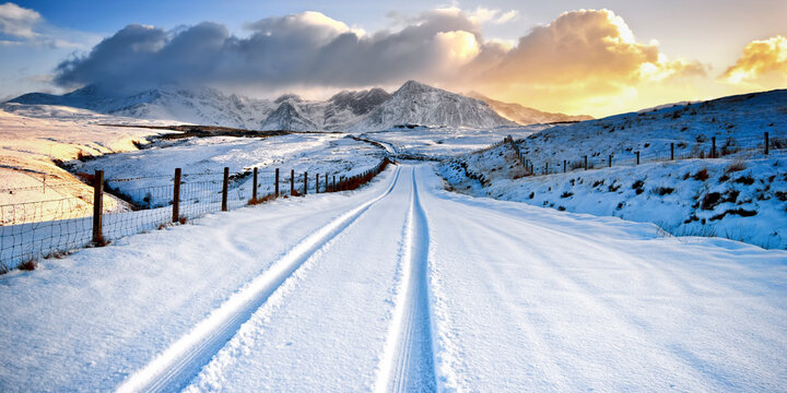 UK, Scotland, View of tyre track and snow mountains
