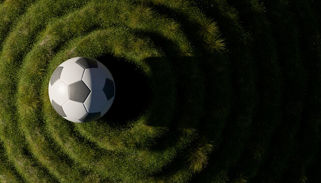 Soccer ball on patterned green grass from directly above