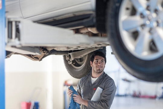 Car mechanic at work in repair garage